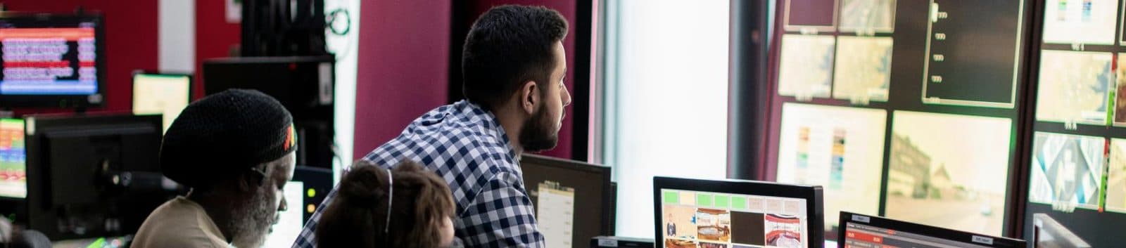 Operations staff working at monitors in a dispatch control room