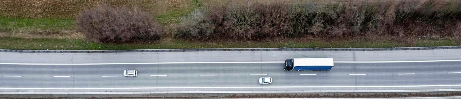 Aerial view of a transport truck travelling a divided highway