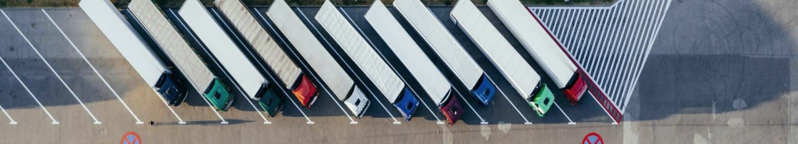 Aerial view of a fleet of trailers lined up in a distribution yard